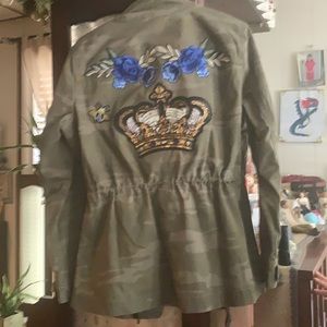 One of a kind piece,green camo field jacket with custom patch work on back.